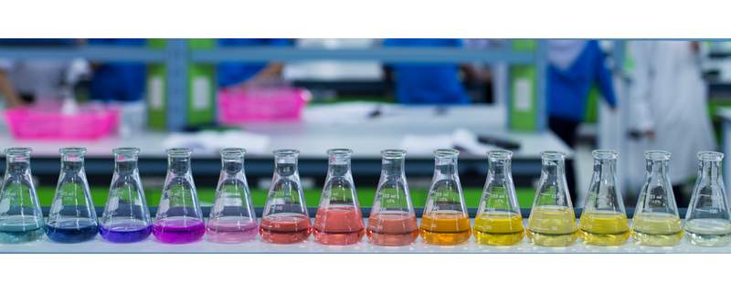 Laboratory flasks holding a range of coloured calibration and test solutions